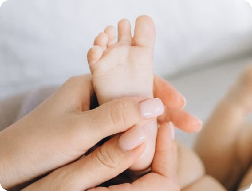 Parent's hands holding a baby's foot