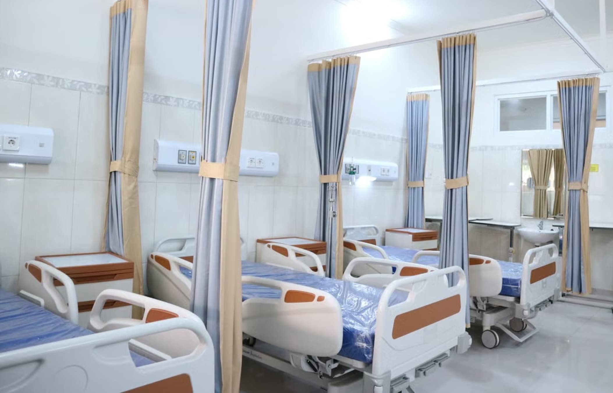 Clinic treatment room with beds and privacy curtains