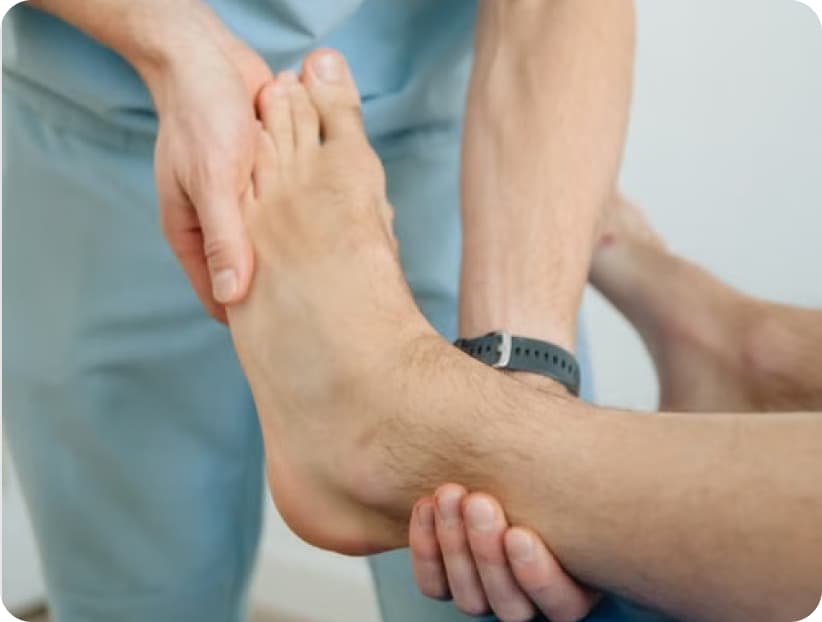 Clinician supporting a patient's ankle during an assessment