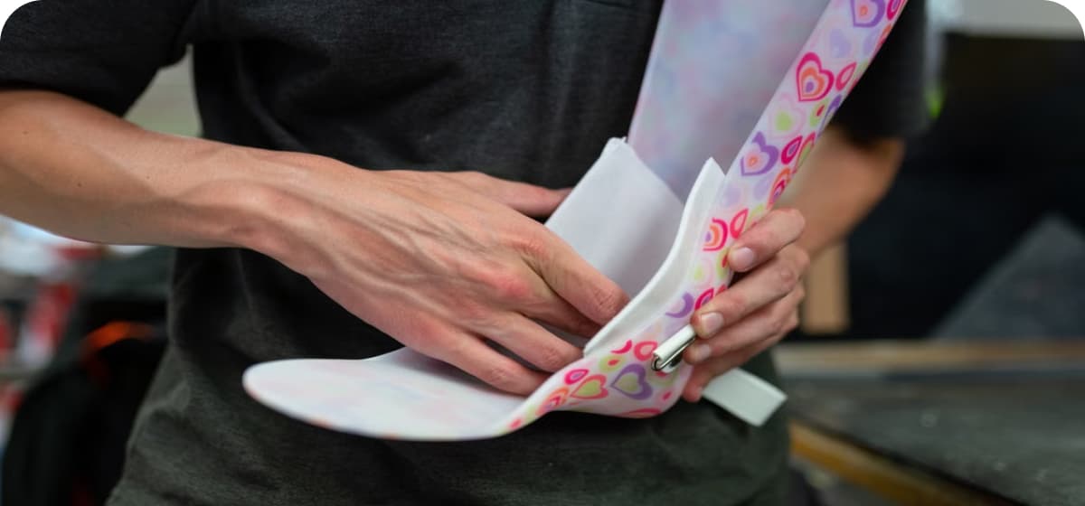 Podiatry technician shaping a custom foot orthotic