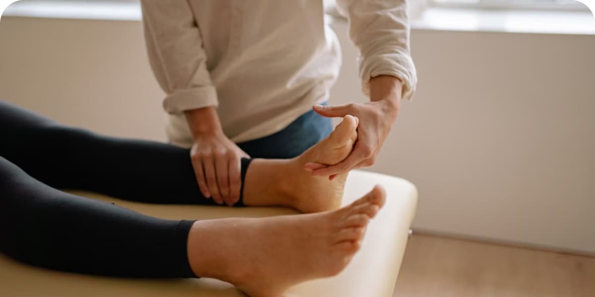 Podiatrist examining a patient's heel and arch