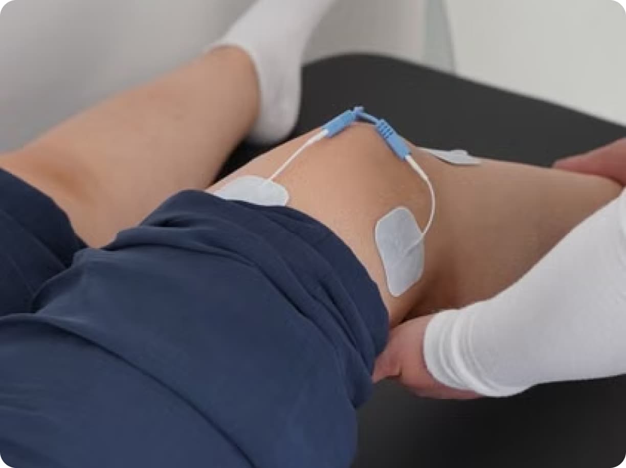 Patient's leg fitted with electrode pads during a lower limb assessment