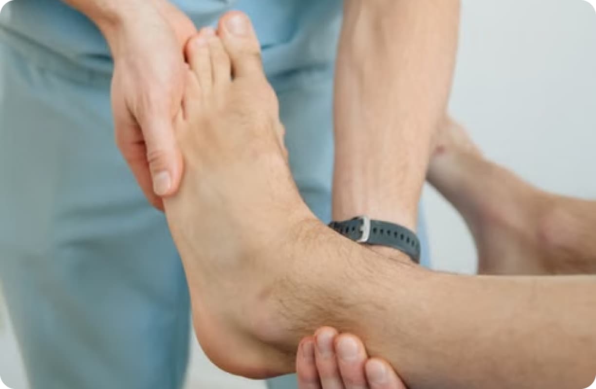 Podiatrist assessing the movement of a patient's ankle